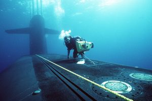a photographers matediver prepares to videotape members of a navy sea air land 24cf58 1600